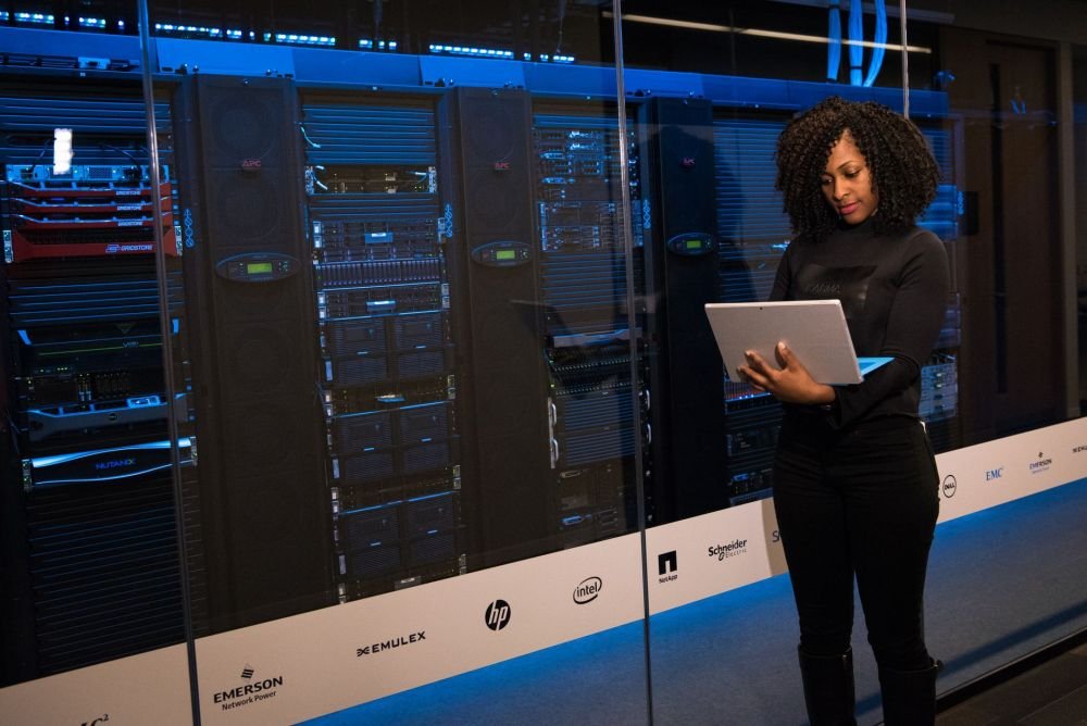 IT engineer configuring a network rack for Fortinet firewall setup in a Dubai office