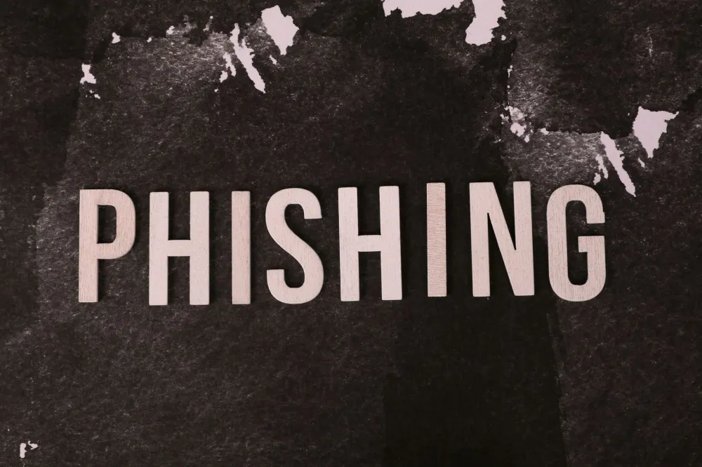 Phishing email warning on a business laptop screen highlighting cybersecurity risks for SMEs