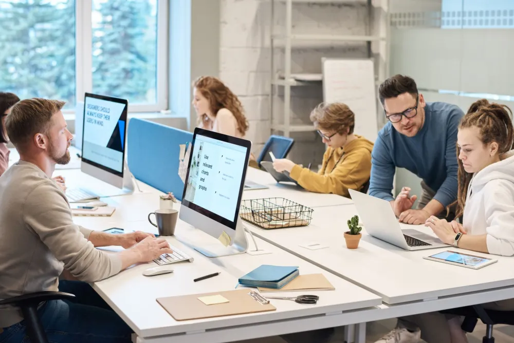 Small business team working on computers protected by a Fortinet firewall in Dubai Marina