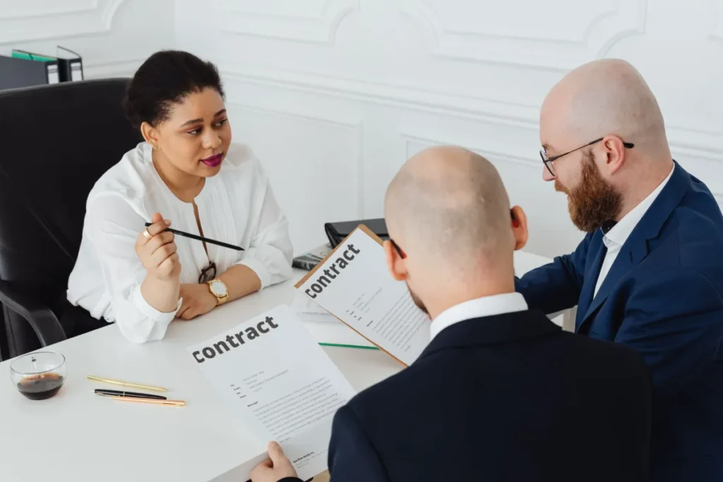 IT engineer reviewing an annual maintenance contract at a JLT office desk