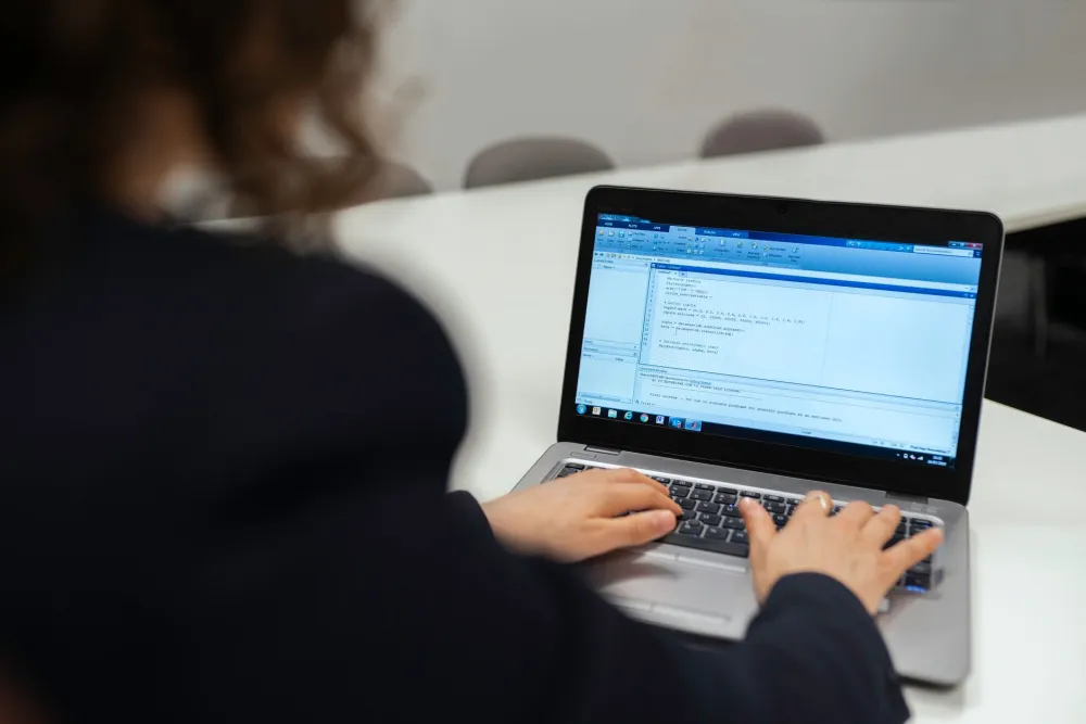 IT engineer running diagnostics on office laptops during an infrastructure review