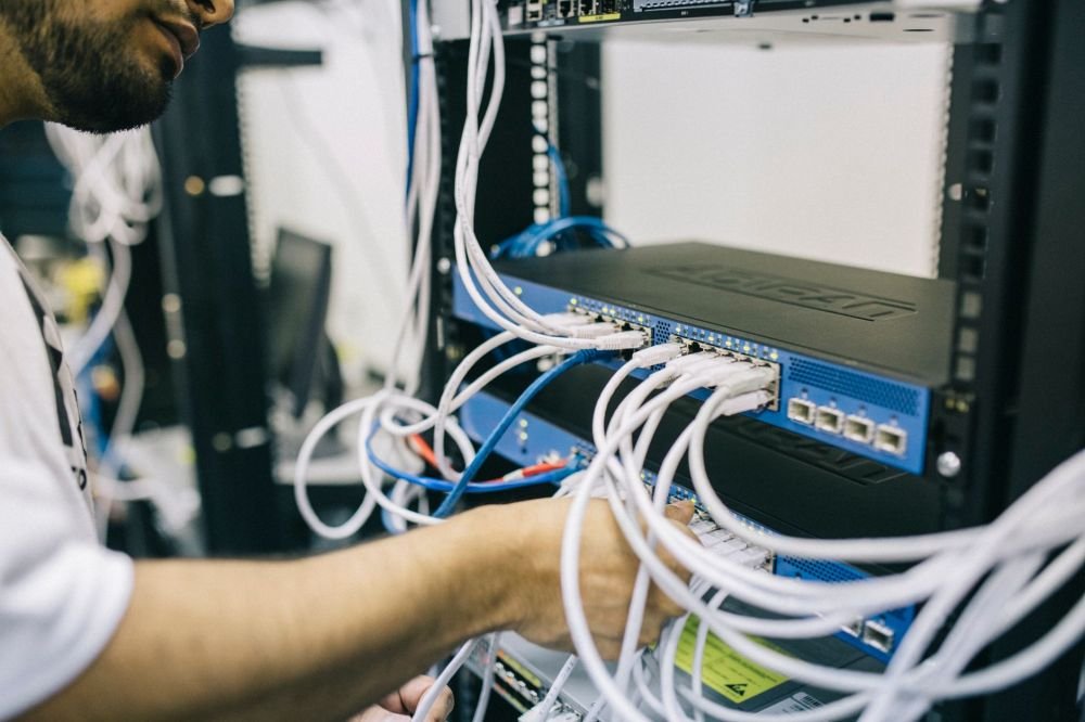 On-site IT support engineer configuring network security for a small business office in Dubai