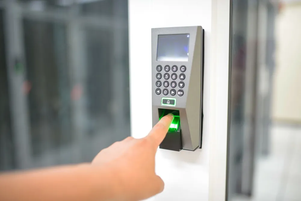 Biometric fingerprint attendance device mounted at an office door for access control