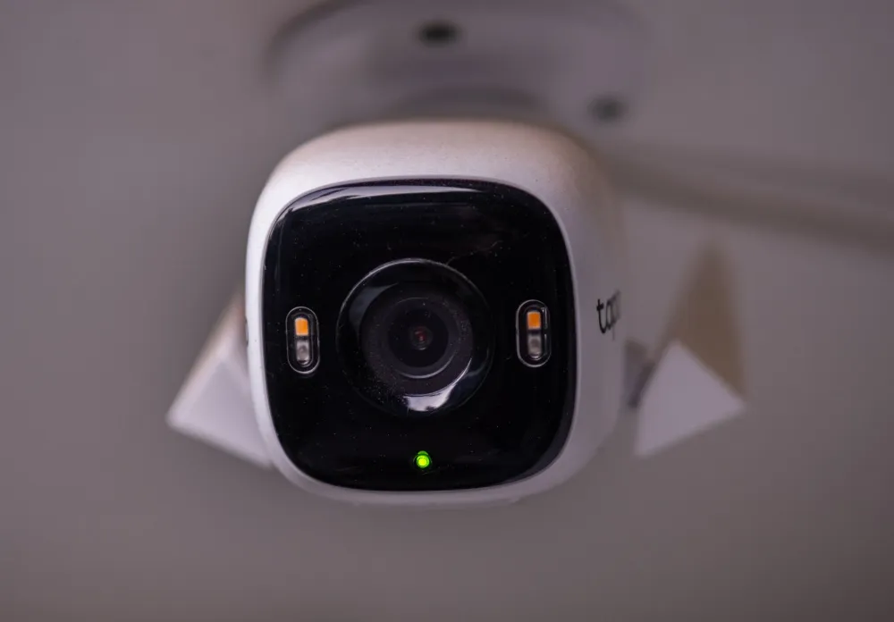 Technician installing CCTV security camera in a modern Dubai office building