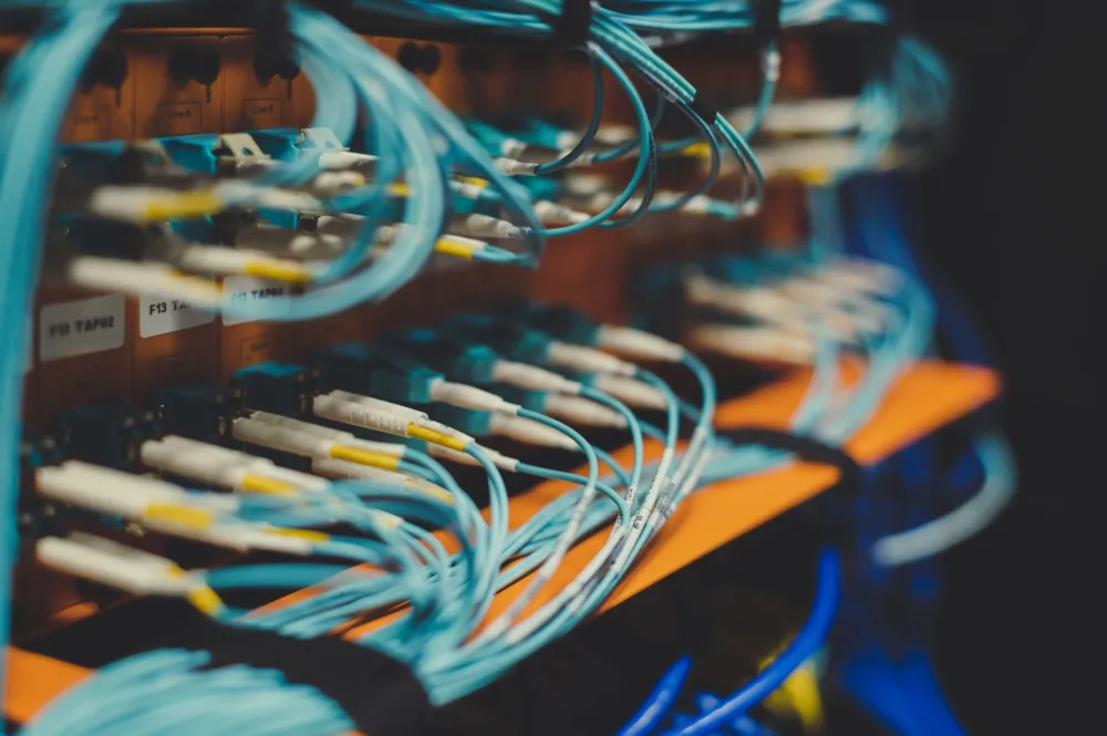 IT engineer configuring Fortinet firewall inside a Dubai office server rack