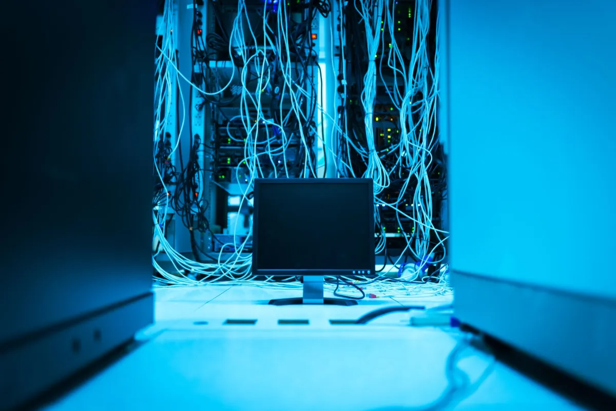 IT engineer performing annual maintenance on a server rack in a Downtown Dubai office