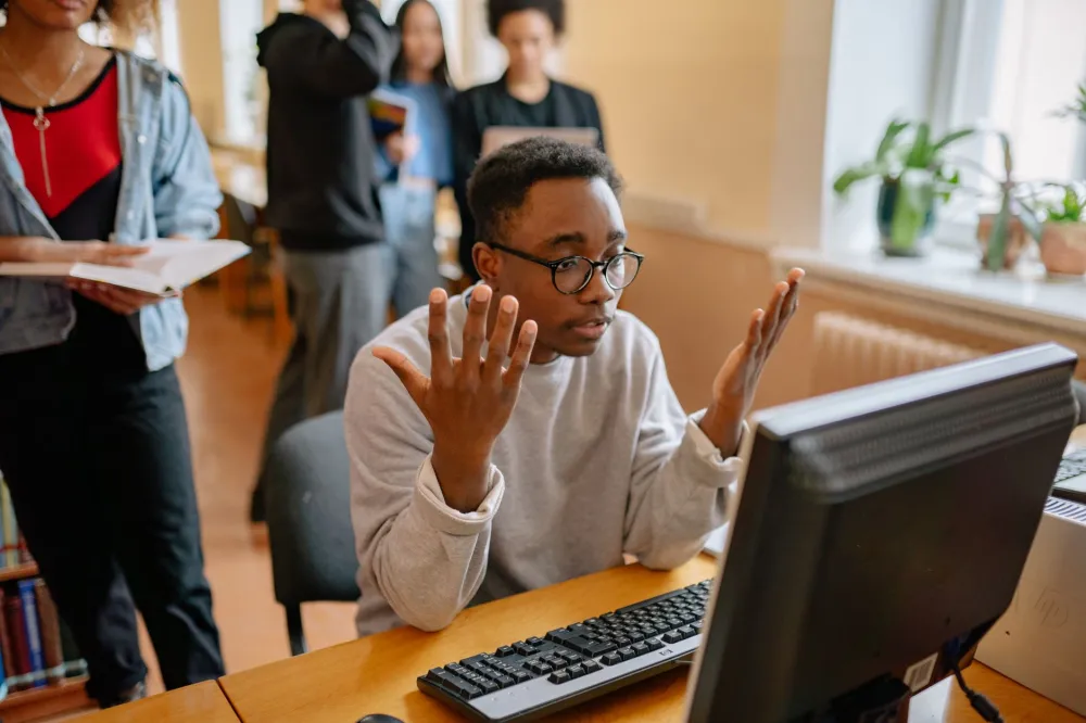 Office worker frustrated by slow computer needing IT support in Jebel Ali