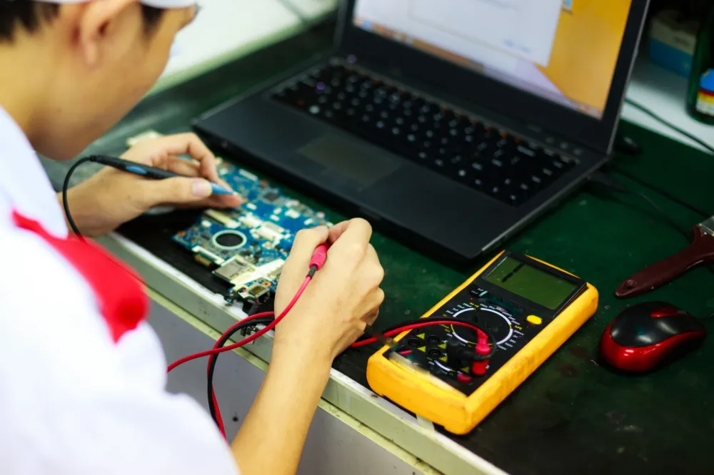 IT technician running diagnostics on a laptop during on-site support visit