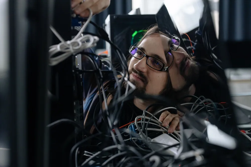 Technician installing structured network cabling for new office IT support in Oud Metha