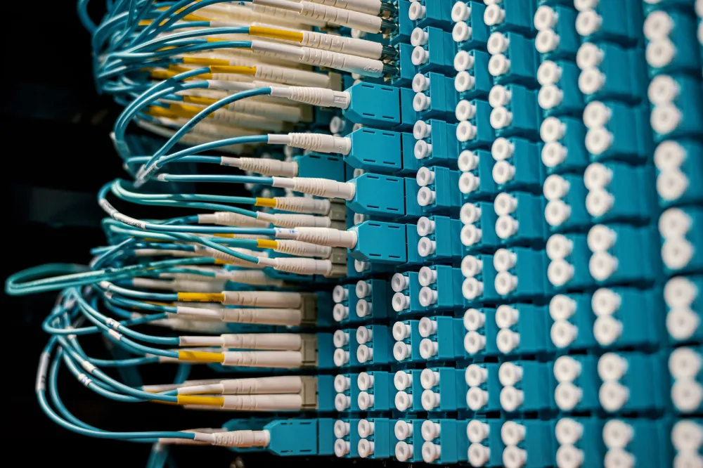 Technician installing network switch rack for managed IT services in a Dubai office