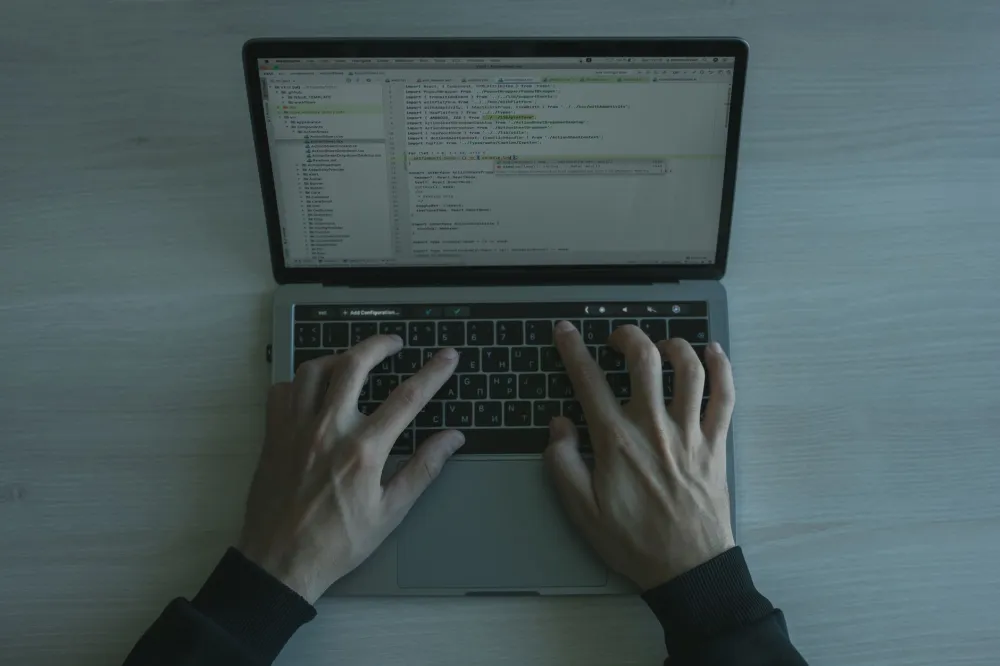 Employee reviewing a cybersecurity checklist on a laptop in a Dubai office