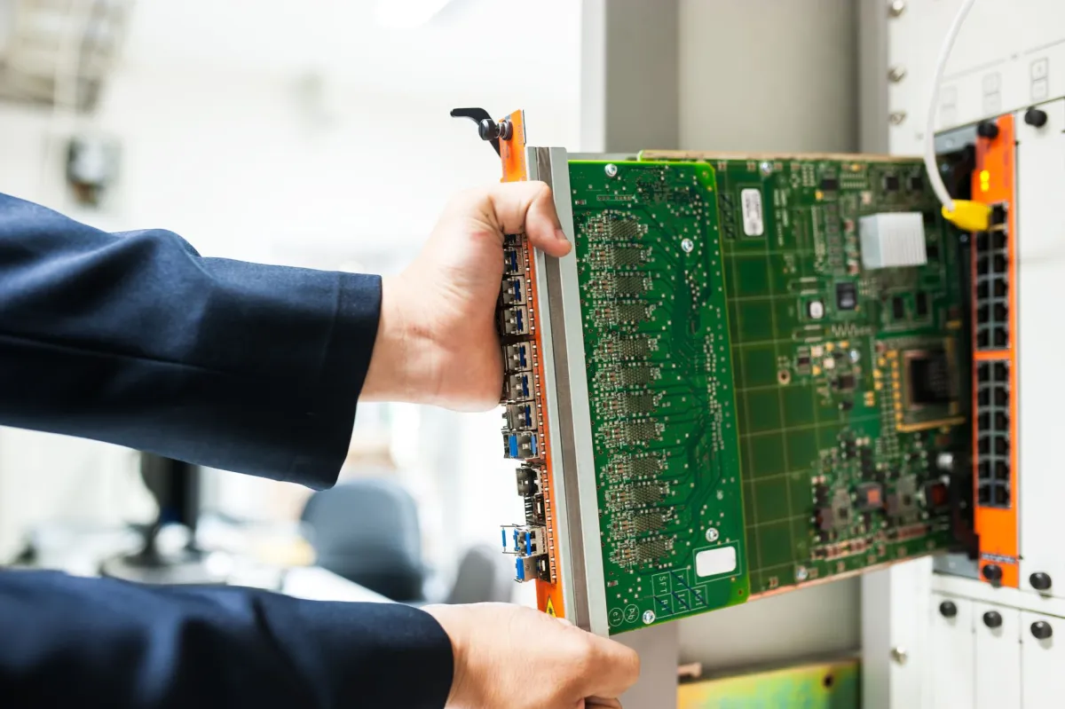 IT engineer configuring managed switch for office network setup in Jebel Ali