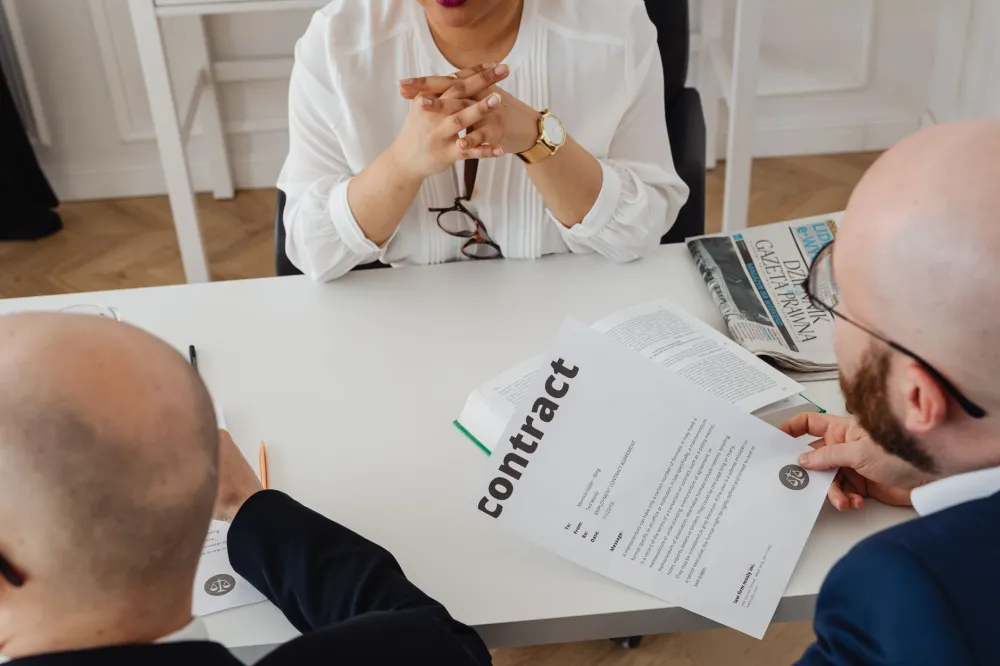 Business owner reviewing software licensing agreement with IT consultant in Dubai