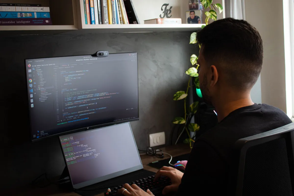 IT engineer setting up desktop computers and printer in a JLT office