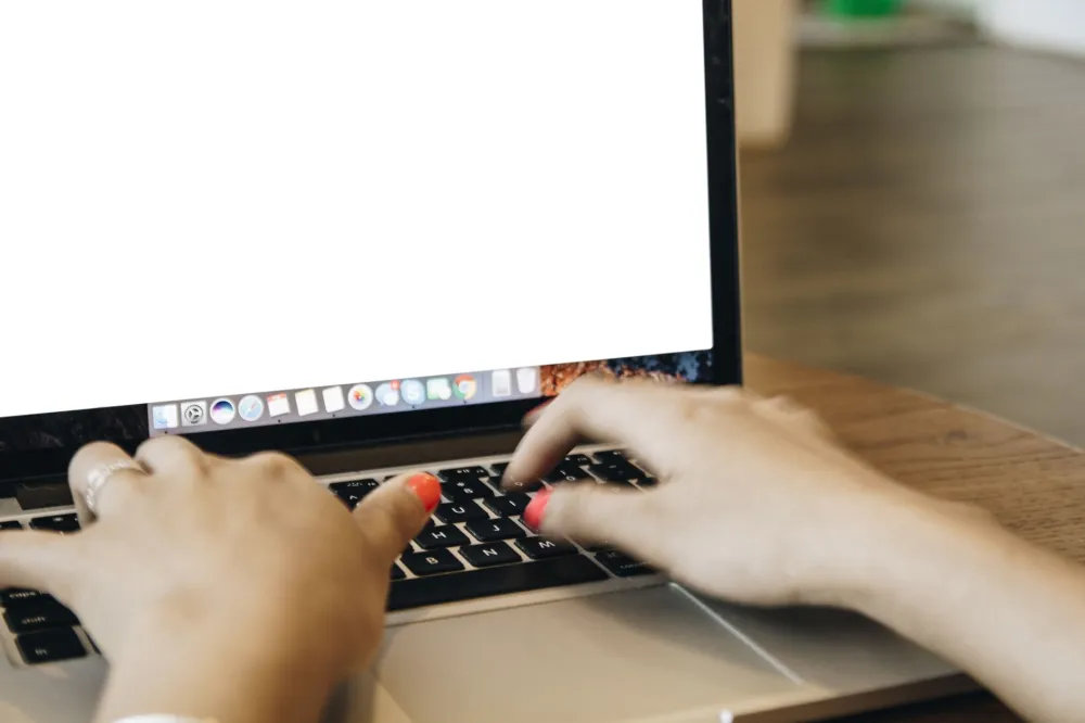 Employee spotting a phishing email on a laptop in a Dubai office