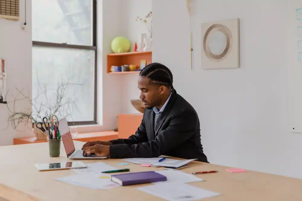 Business owner reviewing network security settings on a laptop in a modern office