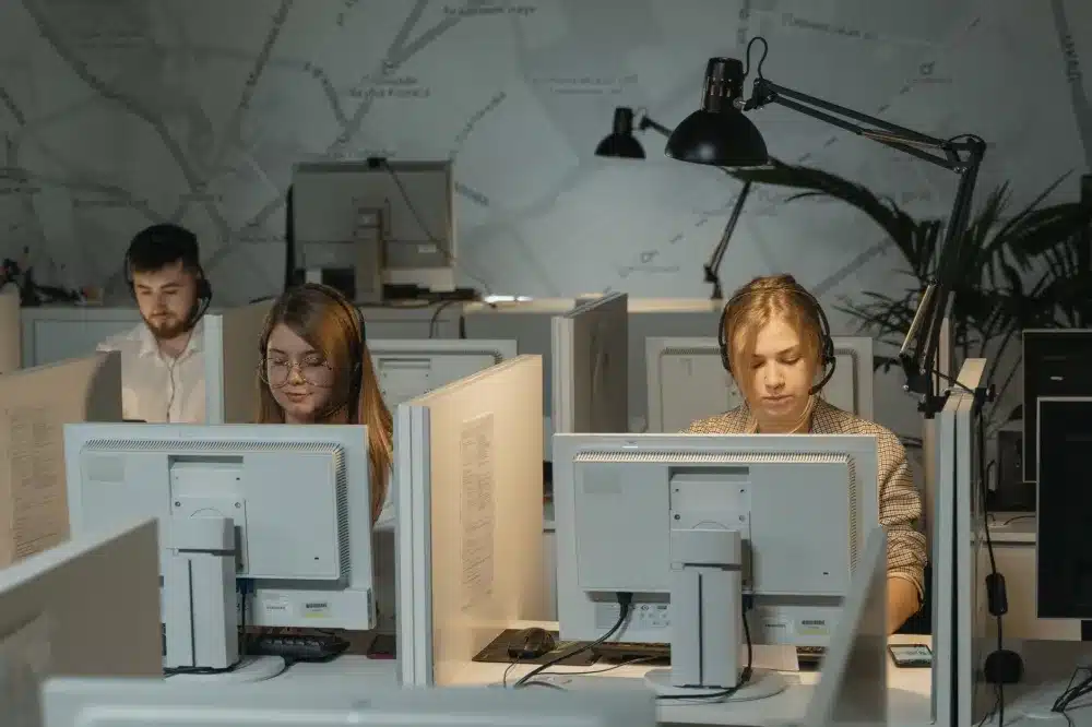 Small business team working on computers in a Mirdif office with secure network connection