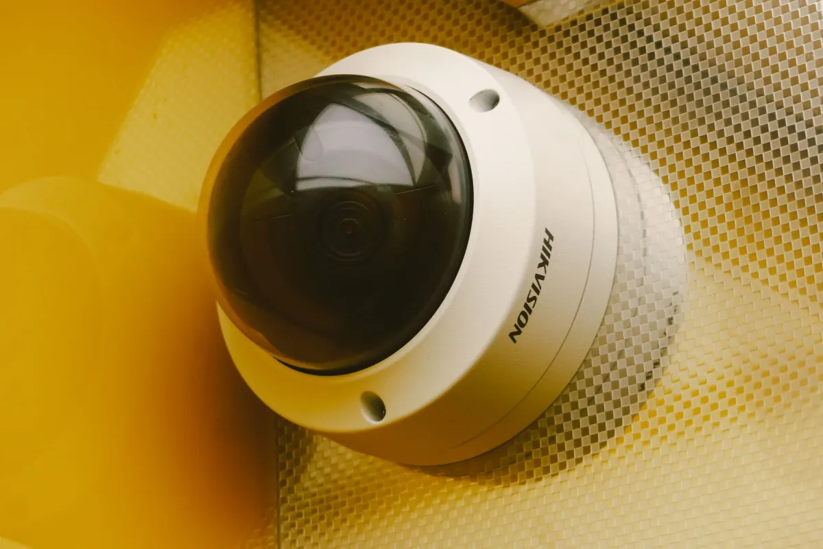 IP camera mounted on office ceiling comparing IP camera vs analog camera systems in Dubai