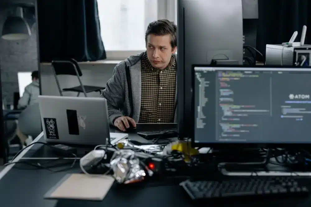 IT support engineer testing network connection on a laptop during office setup