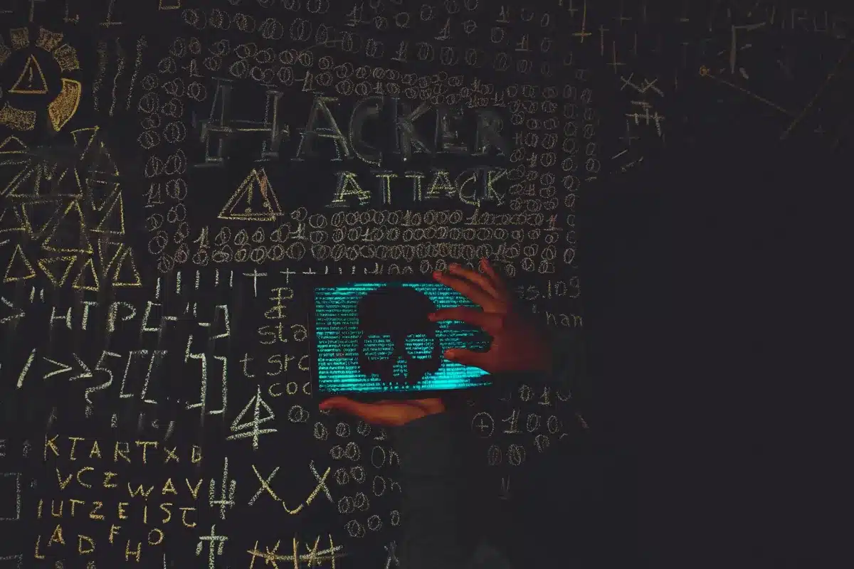 IT engineer reviewing signs a business network has been hacked on a monitor