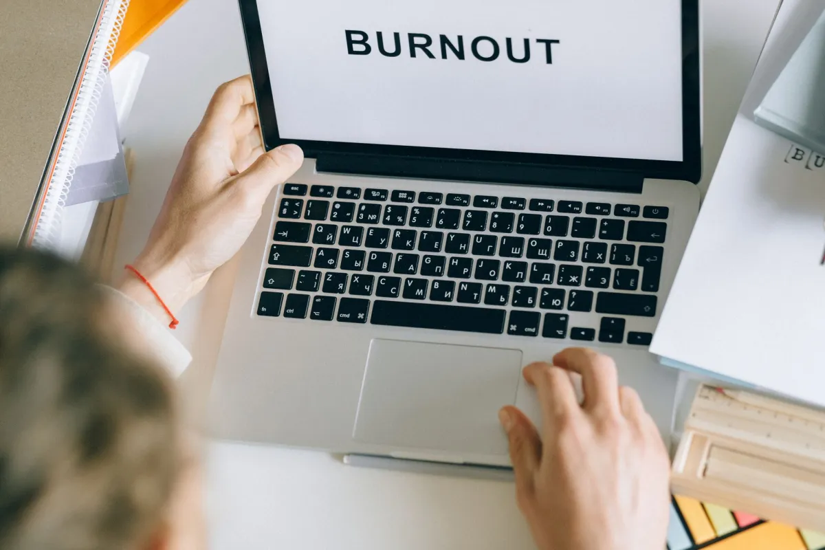 Business owner frustrated by IT downtime at Dubai office desk, signs of outgrown break-fix IT