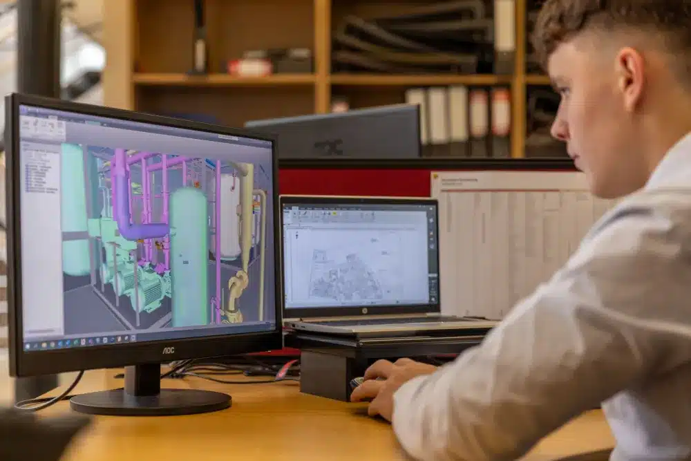 Engineer working on AutoCAD design software on a desktop PC in a Dubai Silicon Oasis office