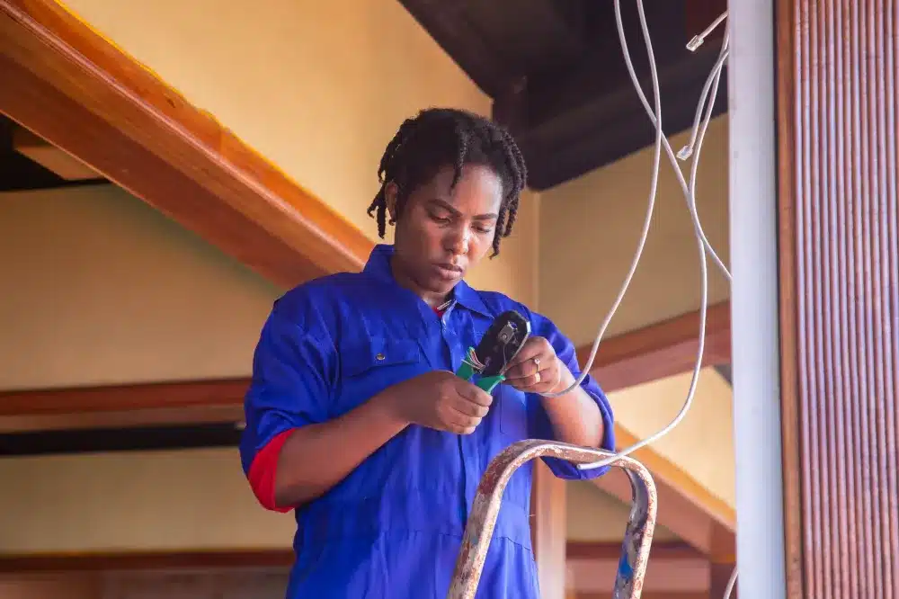 IT engineer running Cat6 cabling for CCTV camera installation in a commercial office