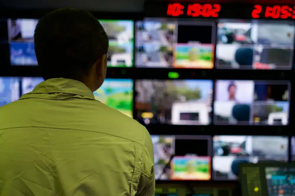 Business owner remotely monitoring CCTV footage on a laptop screen in a Dubai office